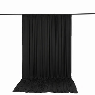 Black photography backdrop curtain with floor drape on crossbar stand