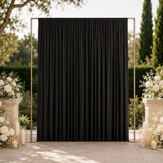 Elegant black wedding backdrop with white floral arrangements outdoors
