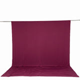 Magenta fabric backdrop and floor drape on hanging rod, studio background
