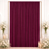 Elegant burgundy curtain backdrop with white roses and candles for events