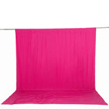 Bright pink fabric backdrop hanging on a support stand