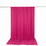 Hot pink draped fabric backdrop with floor pooling on a hanging rod