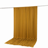 Mustard yellow curtain draped over rod on white background