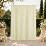 Elegant outdoor wedding backdrop with cream draped curtain and floral décor
