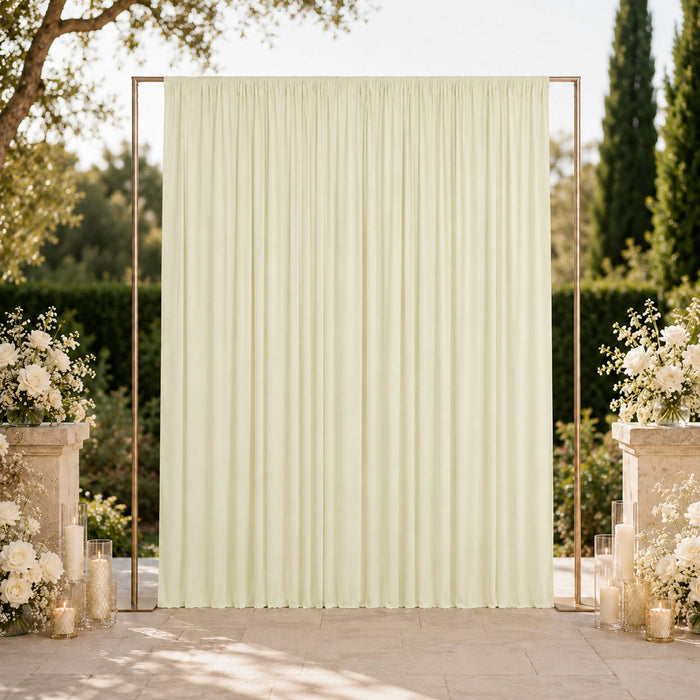 Elegant outdoor wedding backdrop with cream draped curtain and floral décor