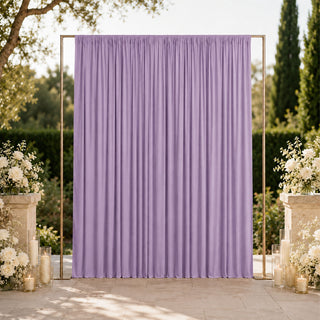 Lavender wedding backdrop with floral arrangements and candles outdoors