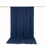 Navy blue draped backdrop curtain on a metal rod, white studio background