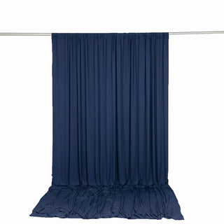Navy blue draped backdrop curtain on a metal rod, white studio background