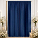 Elegant navy blue curtain backdrop with white roses, candles, and gold frame