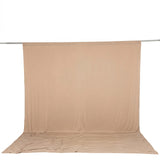 Beige seamless fabric backdrop on a studio stand