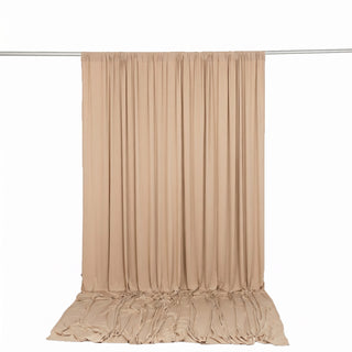 Beige draped backdrop curtain on support rod, studio photography background