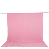 Pink fabric backdrop draped on a metal support stand, studio background.