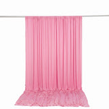 Pink satin backdrop curtain with draped floor panel on hanging rod