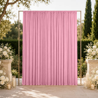 Pink wedding backdrop with gold frame and white floral decor outdoors