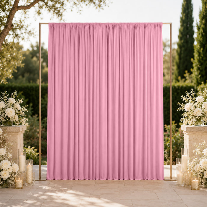 Pink wedding backdrop with gold frame and white floral decor outdoors