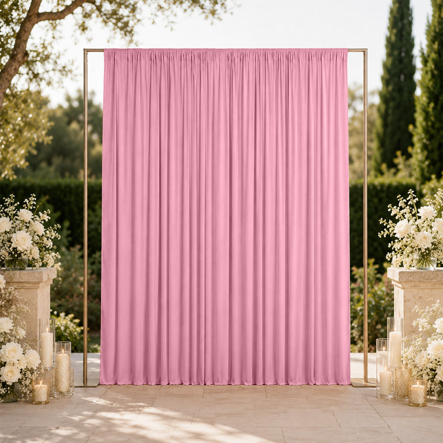 Pink wedding backdrop with gold frame and white floral decor outdoors