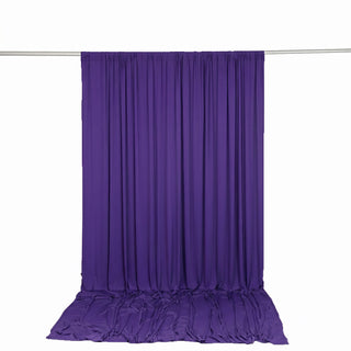 Purple draped backdrop curtain with floor sweep on a white background