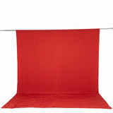 Red photography backdrop with seamless floor and overhead support rod