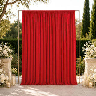 Elegant outdoor wedding backdrop with red curtain and white floral arrangements