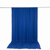 Blue draped fabric backdrop hanging on a silver rod, studio photography setup