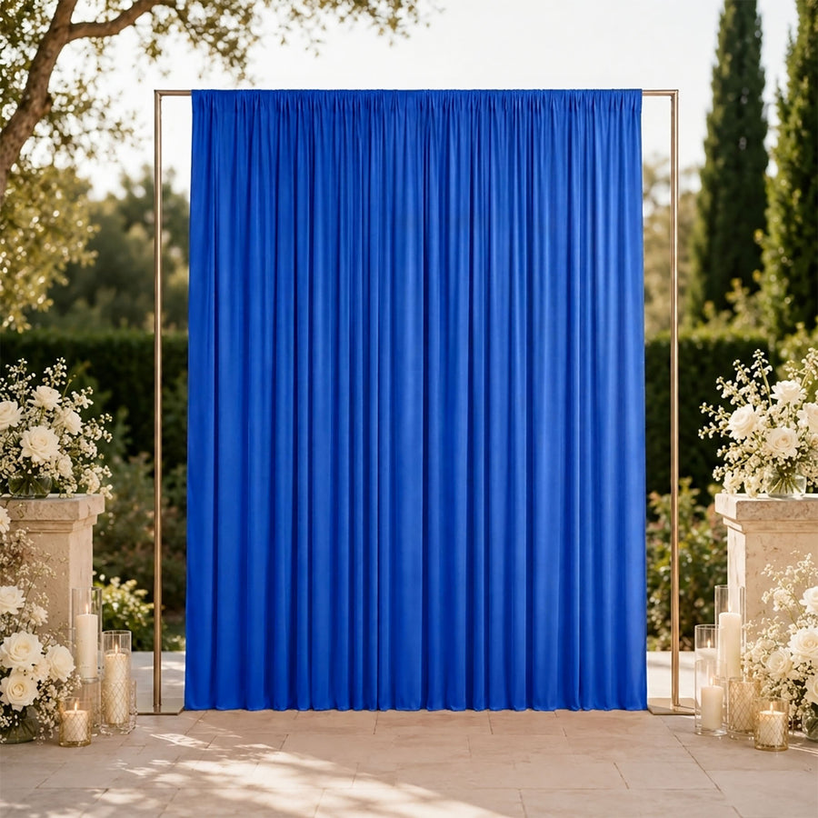 Blue wedding backdrop with gold frame and white floral arrangements outdoors