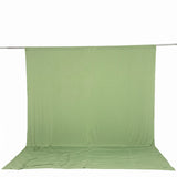 Light green fabric backdrop draped on a studio support stand
