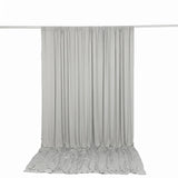 Light gray draped curtain backdrop on crossbar stand with pooled fabric