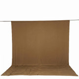 Brown fabric photography backdrop hanging on a support pole and floor