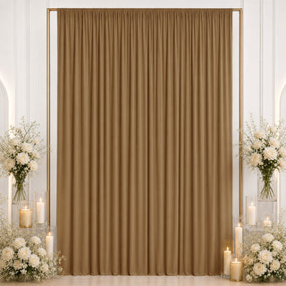 Gold backdrop curtain with white floral arrangements and candle decor for events