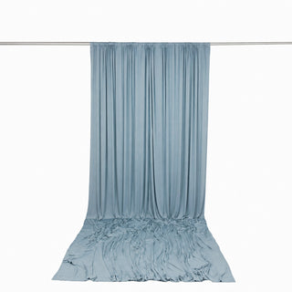Light blue draped fabric backdrop with wrinkled floor sweep on white background