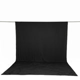 Black photography backdrop with floor drape on support stand, studio background