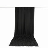 Black draped fabric backdrop hanging on a silver rod, studio display