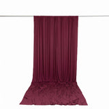Burgundy draped fabric backdrop on hanging rod, studio curtain backdrop