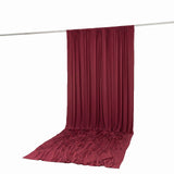 Burgundy draped backdrop curtain on hanging rod, studio photography set