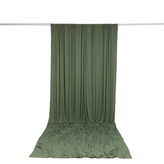 Olive green draped curtain backdrop on studio rod with floor pooling fabric