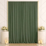 Elegant green curtain backdrop with white floral arrangements and candles