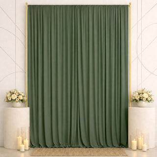 Elegant green curtain backdrop with white floral arrangements and candles