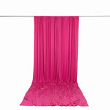 Bright pink draped fabric backdrop hanging on a rod, white background