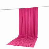Bright pink draped fabric backdrop on a hanging rod, studio-style scene