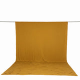 Mustard yellow backdrop fabric hanging on a rod, photography background set
