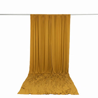 Mustard yellow draped curtain backdrop on rod with floor pooling fabric