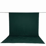 Dark green fabric photography backdrop with floor sweep on support rod