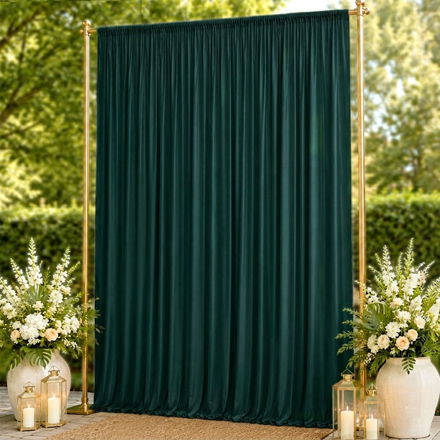 Elegant dark green wedding backdrop with gold frame and floral arrangements