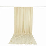 Cream pleated curtain drape on rod with matching floor-length backdrop
