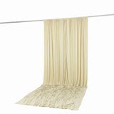 Cream pleated curtain drape on hanging rod with puddled fabric floor panel