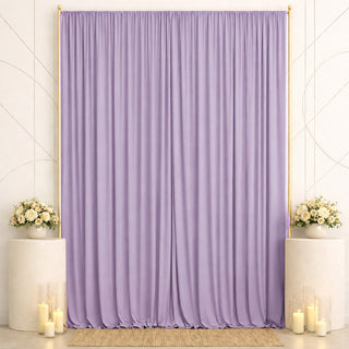 Lavender draped backdrop with floral pedestals and candles for elegant event decor