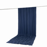 Navy blue draped backdrop curtain on a hanging rod