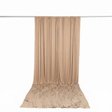 Beige draped fabric backdrop curtain on a studio rod, product display background