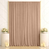 Elegant beige curtain backdrop with floral arrangements and candles