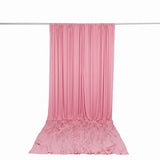 Pink draped fabric curtain backdrop on hanging rod with pooled floor fabric